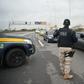 A police officer near an area where a gunman seized a bus and took 16 hostages in Rio de Janeiro, an ordeal that ended hours later when police shot and killed the hijacker