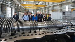 The German economy shrank in the second quarter and could be at risk of recession but German Chancellor Angela Merkel (centre) sees no immediate need for a stimulus package despite strong government finances