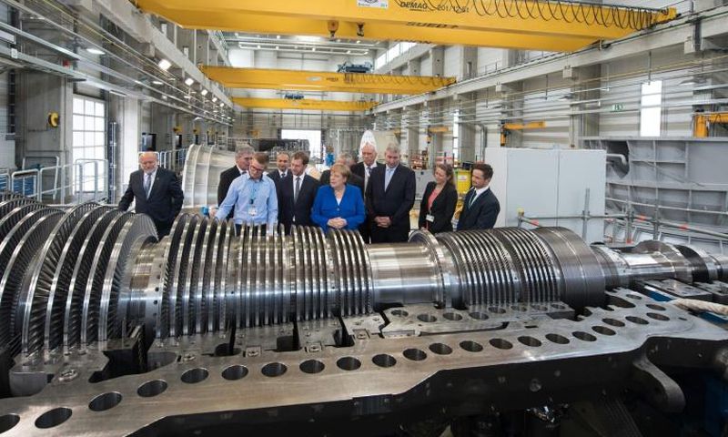 The German economy shrank in the second quarter and could be at risk of recession but German Chancellor Angela Merkel (centre) sees no immediate need for a stimulus package despite strong government finances