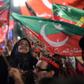 Pakistan Tehreek-e-Insaf supporters wave party flags during campaigning that brought Imran Khan to power in July 2018