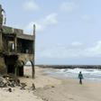 The shore-hugging Alpha Beach road has disappeared under the waves and apartment blocks built with prized ocean views just 10 years ago are now occupied only by squatters