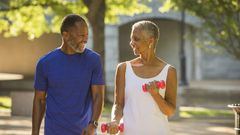 Black couple walking in park