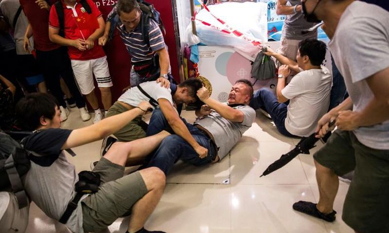A Beijing supporter fights with an anti-government protester inside a shopping mall in Kowloon Bay.The Hong Kong protests have increasingly pitted ordinary people against each other