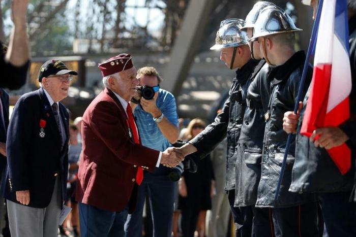A veteran meets firefighters at the Eiffel Tower