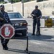 Security forces loyal to Palestinian Islamist movement Hamas man a checkpoint and stop vehicles in Khan Yunis in the southern Gaza Strip on Wednesday after two explosions overnight