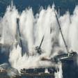 The remains of the 4,500-tonne bridge collapsed in seconds as officials and locals watched the demolition from a distance