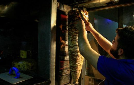 The tantalising odours of popular Syrian dishes of shawarma, fatteh and garlic sauce fill the air of the Kafouri district in Sudan's capital Khartoum