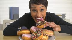 Woman eating doughnut(shutterstock)