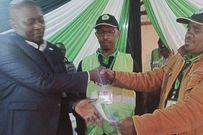 Musee Mati of Maendeleo Chap Chap (left) receives the IEBC election certificate for Mutonguni Ward