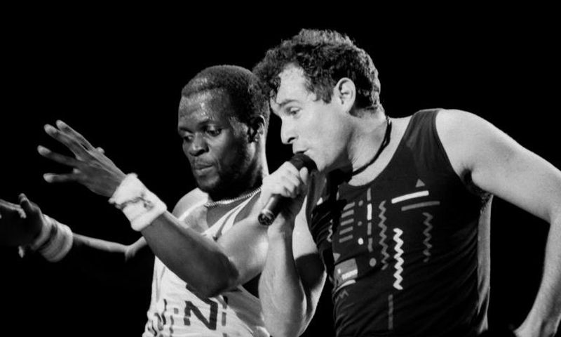 Johnny Clegg (R) performed in the band Savuka for years under apartheid until group member Dudu Zulu (L) was shot dead in 1992 and dancer Dudu Zulu of South African band Savuka perform on stage at the Amnesty International Concert on October 10, 1988 i...