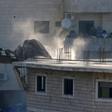A Palestinian family watches Israeli security forces as they demolish a Palestinian buildings in the Jerusalem area on July 22, 2019