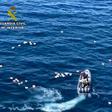 This handout picture released by the Spanish Guardia Civil shows a speedboat surrounded by bundles of drugs in the sea, after a police high-speed chase with drug-smugglers, off the coast of Mijas, Malaga, southern Spain