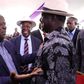 Raila Odinga with Fred Matiangi at the burial of Hezron Manduku