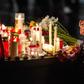 People leave candles and flowers at a vigil at the Marktplatz in Halle, eastern Germany