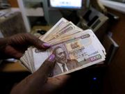 A woman handling old Ksh1,000 notes. Kenyan pays for luxury Sh7 million Mercedes with old Sh1,000 note trying to beat deadline
