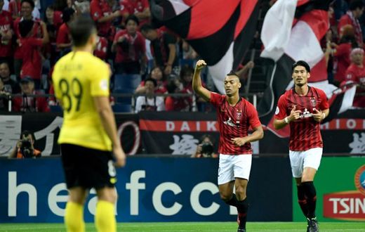 Urawa's midfielder Fabricio raises his arm to celebrate his first-half goal against Guangzhou Evergrande during the AFC Champions League semi-final first leg in Saitama