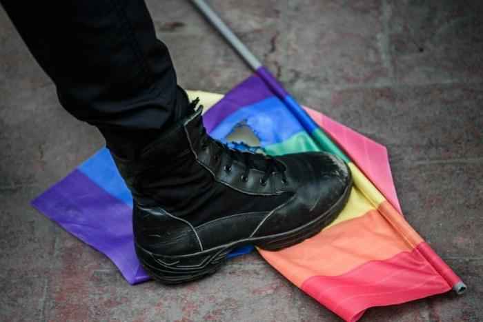 A police officer steps a rainbow flag during a 2016 LGBT protest in Turkey, where there has been a recent clampdown on pro-gay rights events