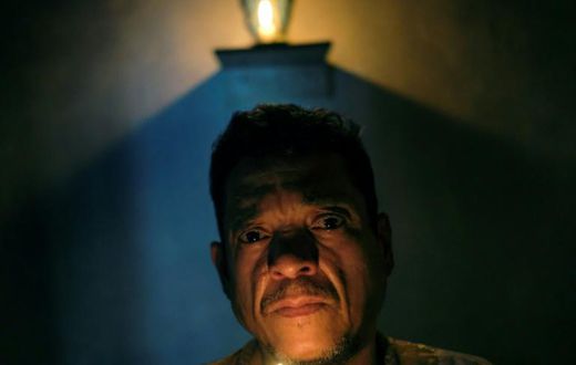 Venezuelan spiritual healer "Brother Guayanese" poses at his clinic in the Caracas neighborhood of Petare