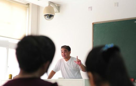 Ilham Tohti, a Uighur scholar imprisoned in China whom the European Parliament has put on its shortlist for the Sakharov Prize, lectures in a classroom in Beijing in 2010
