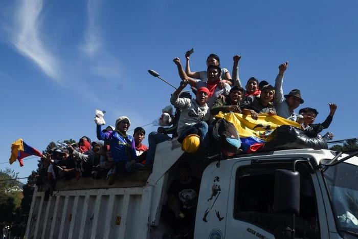 Protesters celebrate as they leave in Quito after Ecuador's president and indigenous leaders reached an agreement to end violent protests