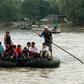 Locals and Central American migrants use a makeshift raft to cross the Suchiate river from Guatemala to Mexico -- Mexico is racing to implement a deal with the United States to curb migration