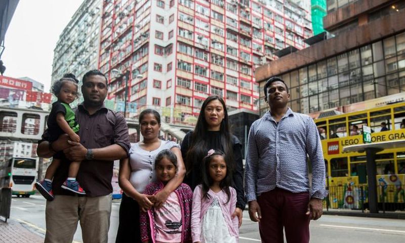Sri Lankan refugees Nadeeka Nonis (3rd L) with her partner Supun Thilina Kellapatha (2nd L) and children Sethumdi (4th L) and Dinath (L) pose, seen in 2017 with others who sheltered ex-fugitive Edward Snowden, are seeking asylum in Canada