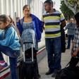Migrants from Honduras wait in line at the Mexico-United States border crossing in Tijuana, Mexico on September 12, 2019
