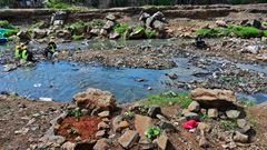 Rock arrangements mark the ground where authorities say bodies, mostly babies, were recovered from Nairobi's rivers