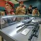 Members of Russia's Young Army patriotic movement get a close-up look at Russia's iconic Kalashnikov at a Moscow exhibition dedicated to their inventor
