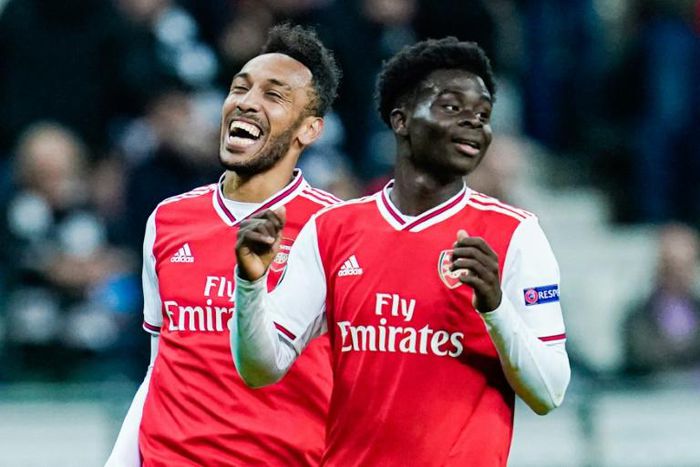 Arsenal striker Pierre-Emerick Aubameyang (L) and teenage forward Bukayo Saka celebrate after scoring scoring during the Europa League win at Eintracht Frankfurt on Thursday