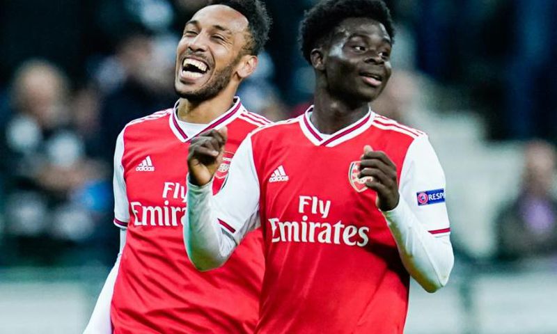 Arsenal striker Pierre-Emerick Aubameyang (L) and teenage forward Bukayo Saka celebrate after scoring scoring during the Europa League win at Eintracht Frankfurt on Thursday