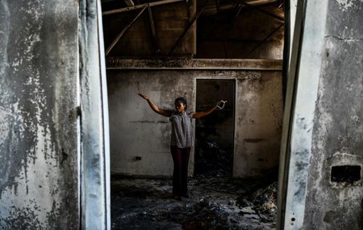 Magalie Noel Dresse, owner of the Caribbean Craft factory, walks through the remains of the factory in Port-au-Prince