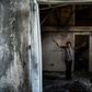 Magalie Noel Dresse, owner of the Caribbean Craft factory, walks through the remains of the factory in Port-au-Prince
