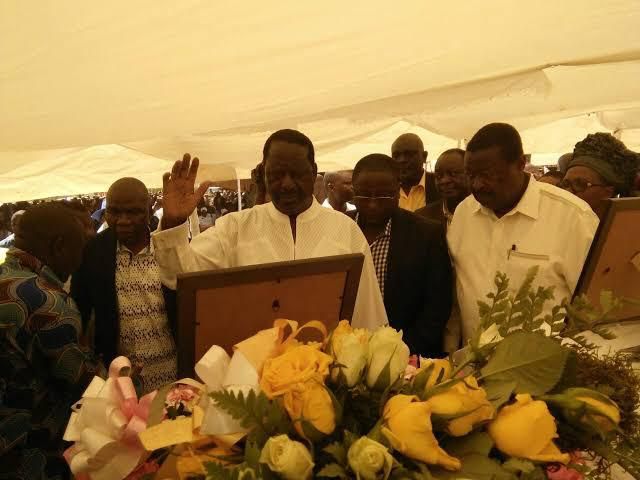 The former Prime Minister during a past funeral. Raila Odinga gives his trademark salute for the dead at Precious Talents School