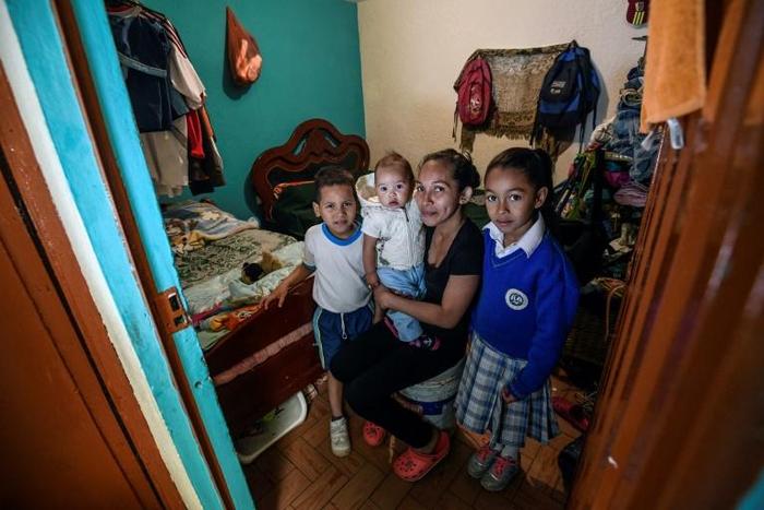 Venezuelan Yisela Palencia poses with her children in Bogota, Colombia