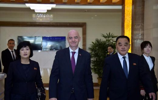 FIFA President Gianni Infantino (C) was one of the few people allowed to see the surreal game play out