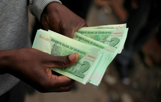 A man holds "bond notes" equivalent to US dollars released by the Reserve Bank of Zimbabwe to ease critical cash shortages