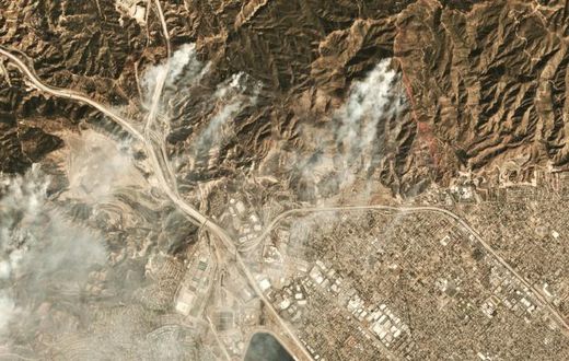 Smoke from the Saddleridge fire about 20 miles north of downtown Los Angeles is seen in this image from Planet Labs Inc
