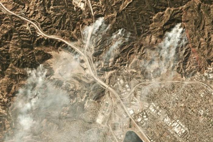 Smoke from the Saddleridge fire about 20 miles north of downtown Los Angeles is seen in this image from Planet Labs Inc