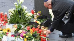 A man wearing a kippah skullcap places a candle at a makeshift memorial a day after two people were shot dead as Halle's Jewish community marked Yom Kippur