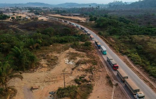 An aerial view of trucks queueing on the BR163 in Brazil's Para state -- one of two major transport routes that have played a key role in the development and destruction of the Amazon, the world's largest rainforest