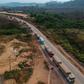 An aerial view of trucks queueing on the BR163 in Brazil's Para state -- one of two major transport routes that have played a key role in the development and destruction of the Amazon, the world's largest rainforest