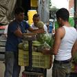 A man sells fruits and vegetables at a street market in Caracas, where a greater choice of products exist, on July 25
