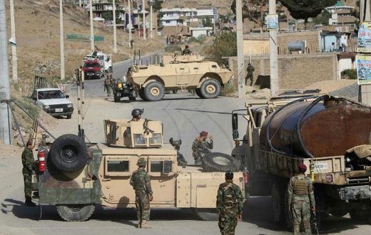 Afghan National Army soldiers stand guard and inspect the site of a suicide car bomb attack by the Taliban in Char Asiab district, south of Kabul, on September 12