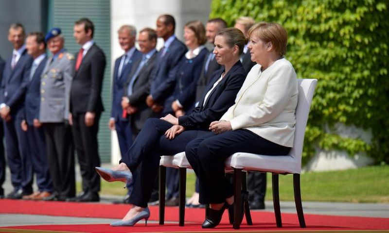German Chancellor Angela Merkel and Denmark's Prime Minister Mette Frederiksen sat as they listened to the national anthems