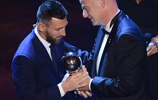 Argentina and Barcelona forward Lionel Messi (L) is presented with the men's player of year award by FIFA President Gianni Infantino.