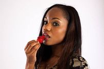 Woman eating strawberry (FreeImages)