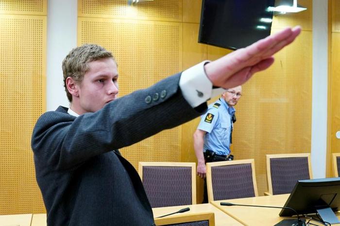 Police say Philip Manshaus, seen giving a Nazi salute at a court appearance on September 9, killed his Chinese origin step-sister in a racist attack before opening fire in an Oslo mosque