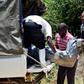 Police officers loading a dead body in a van in a past murder