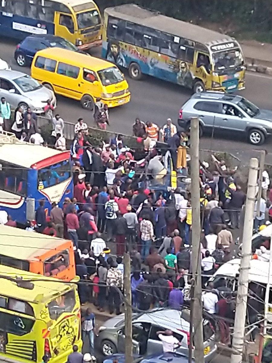 Members of the public assist passengers on 14-seater matatu that overturned at Ngara along Murang'a Road